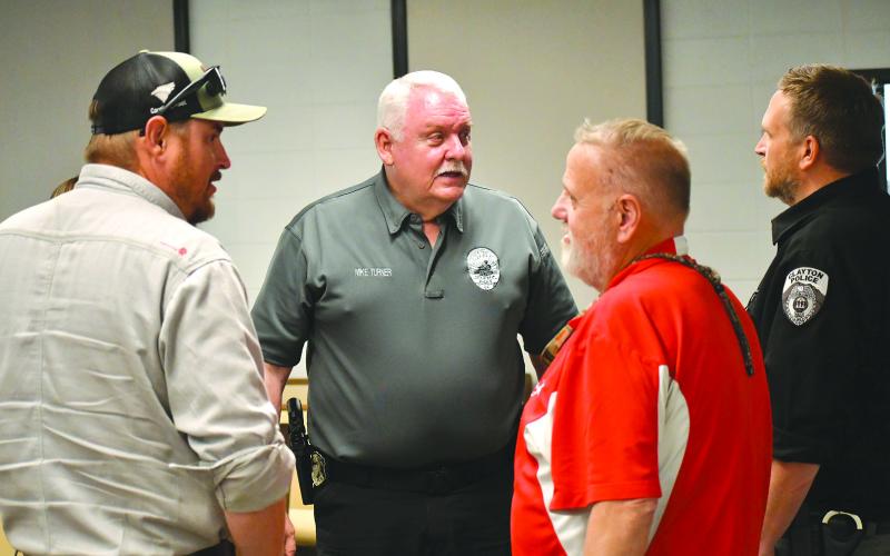 Enoch Autry/The Clayton Tribune. Newly hired Clayton Police Chief Mike Turner (center) talks with council member Channing Watts, Planning and Zoning Administrator Richard Moncus and interim Police Chief Lt. Matt Thomas at the conclusion of Tuesday’s meeting at city hall. Turner’s start date in Clayton is May 1.