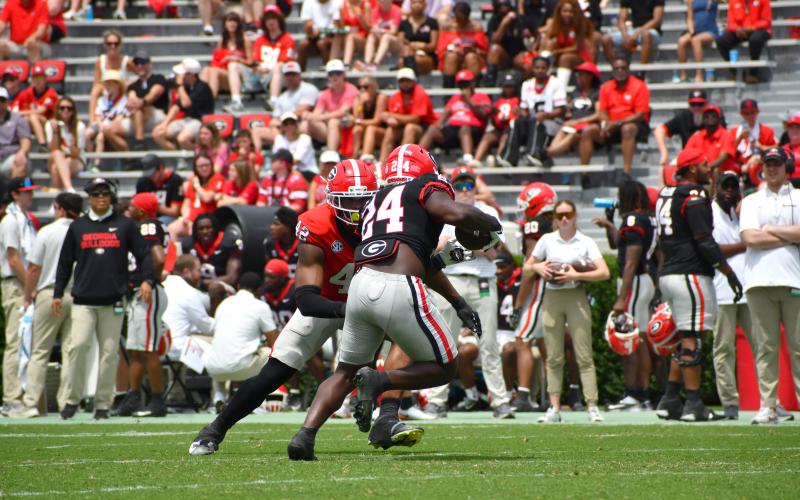 Wesley Branch/The Clayton Tribune. Georgia running back Bo Walker evades a Red Team defender during Georgia’s G-Day scrimmage. Walker spent one season at Rabun Gap-Nacoochee School and was a member of the Eagles’ 2024 state championship team.