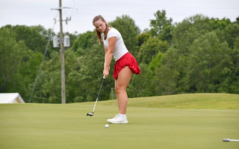 Wesley Branch/The Clayton Tribune. Rabun County sophomore Bella Hulsey watches as her putt rolls towards the hole during Rabun County’s area golf tournament at Chimney Oaks on April 27. Hulsey and the Lady Cats qualified for the state championship match for the first time since 2019.