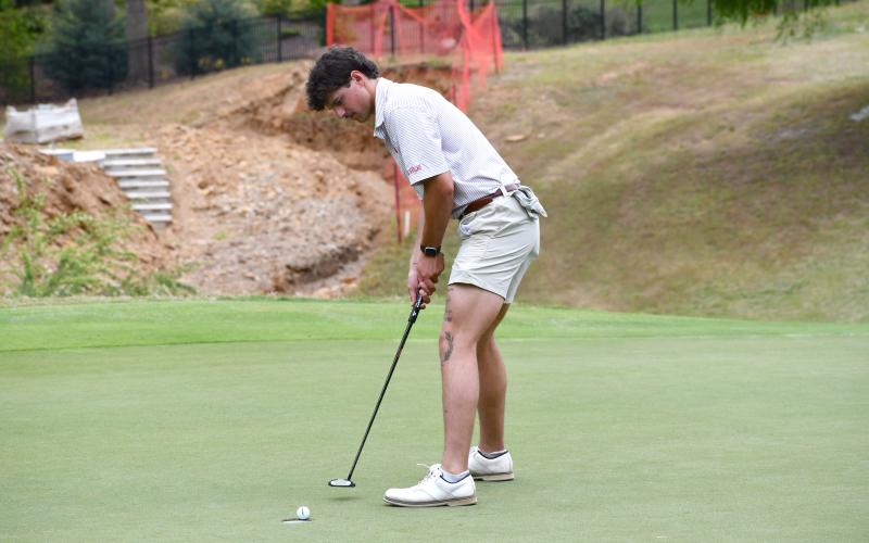 Wesley Branch/The Clayton Tribune. Rabun County senior Ty Truelove watches as his putt drops into the hole during Rabun County’s area golf tournament on April 27 at Chimney Oaks. Truelove qualified as an individual for the state championship.