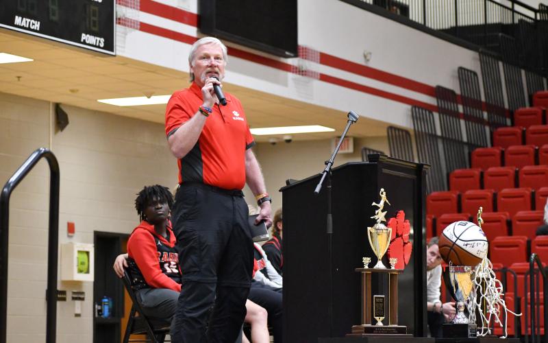 Wesley Branch/The Clayton Tribune. David Rogers, the associate pastor of youth and ministry at Clayton Baptist Church, addresses the crowd and team as the guest speaker at RCHS’ celebration for the boys basketball state title team at Rabun County High School on March 26.