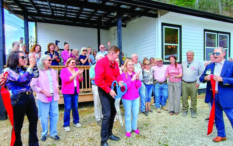 Megan Horn/The Clayton Tribune. Community members celebrate and show support on March 31 to the nonprofit Women of Worth (WOW) Recovery as the ribbon is cut on the first residential substance-abuse recovery center in Rabun County. Forward Rabun/Rabun County Chamber of Commerce held an official ribbon cutting and grand opening celebration. It is located at 5989 Highway 441, Lakemont, and can be reached by telephone by contacting 706-782-9761.