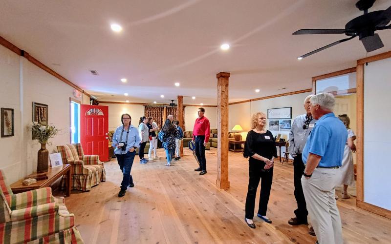 Megan Horn/The Clayton Tribune. Community members at the March 31 grand opening and ribbon cutting of the Women of Worth (WOW) Recovery Dorm take a tour of the facility which includes a living room, group area and kitchen, among other amenities and resources. The first clients are expected to move in mid-April.