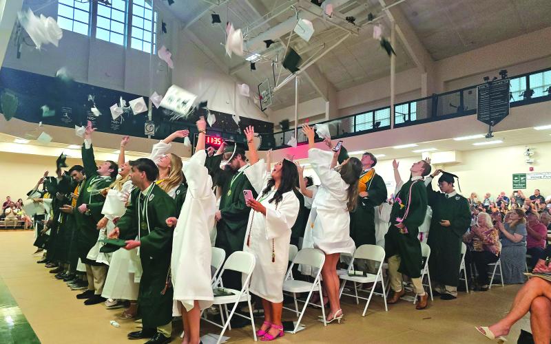Enoch Autry/The Clayton Tribune.  The graduating class of the Tallulah Falls School toss their caps into the air at the conclusion of the May 22 commencement inside the TFS Lower/Middle School Campus Activity Center.