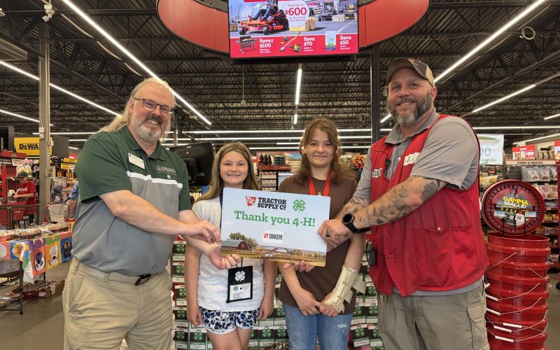 Photo courtesy of Rabun County 4-H. Rabun County 4-H Educator Joey Eller receives a gift card from Clayton Tractor Supply Company Manager Ricky Albright, as 4-H’ers Maleigha Beck and Karsen Pendrey observe.