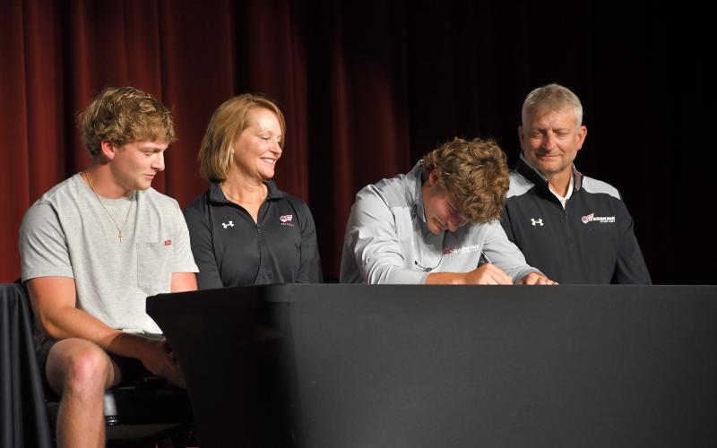 Wesley Branch/The Clayton Tribune. Rabun County senior Reid Giles signs his letter of intent to Erskine College while accompanied by his family on April 30 at the Rabun County High School Fine Arts Building. Giles was a two-time All-State selection as a member of the Wildcat football program.