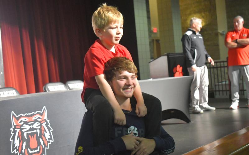 Wesley Branch/The Clayton Tribune. Rabun County senior Huey Blalock hoists Cal Burrell, one of the RCHS boys basketball team’s “goons,” on his shoulders for a picture following RCHS’ signing day festivities on April 30 at the Rabun County High School Fine Arts Building. Blalock signed to continue his basketball career at the Naval Academy.