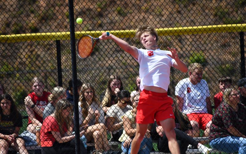 Wesley Branch/The Clayton Tribune.  Rabun County junior Landan Bedingfield loads up to strike the ball during RCHS’ state playoff match versus Swainsboro on May 4. The doubles pairing of Bedingfield and RCHS senior Brady Darnell earned the match-clinching point with a 6-0, 6-3 win.