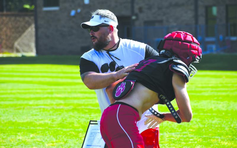 Wesley Branch/The Clayton Tribune.  Rabun County special teams coordinator, tight ends coach and director of football operations Jake Boldin works with Rabun County football players during RCHS’ spring practice on May 5. Boldin was hired in January to replace Ty Maxwell, who will begin a new role as assistant principal in July.