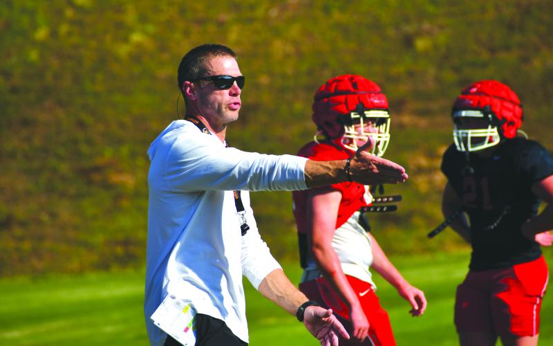 Wesley Branch/The Clayton Tribune. New Rabun County defensive coordinator Luke Coleman directs the Wildcat defense during Rabun County’s spring football practice on May 5 at Rabun County High School. Coleman was hired in January to lead the defense and program’s strength and conditioning program.