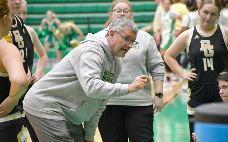 Wesley Branch/The Clayton Tribune. RGNS head girls basketball coach Dale Earnhardt directs his team during a timeout against Buford.