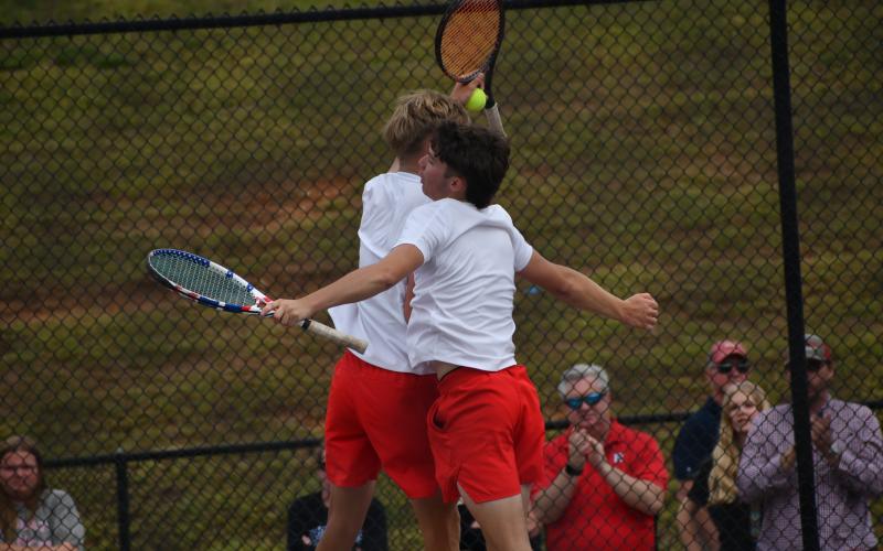 Wesley Branch/The Clayton Tribune. Rabun County’s Brady Darnell and Landan Bedingfield celebrate after winning their doubles match and securing the match-clinching point on No. 2 doubles versus Model on May 8. The RCHS boys will play for the state championship for the first time in program history.