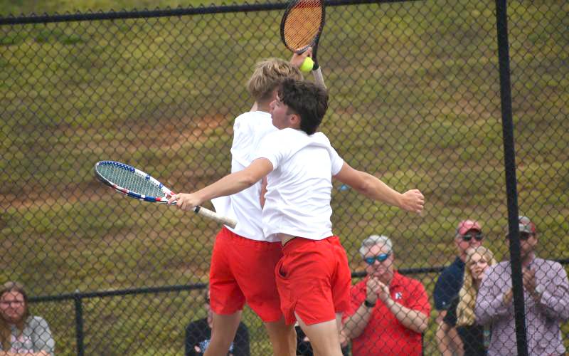 Wesley Branch/The Clayton Tribune. Rabun County’s Brady Darnell and Landan Bedingfield celebrate after winning their doubles match and securing the match-clinching point on No. 2 doubles versus Model on May 8. The RCHS boys will play for the state championship for the first time in program history.