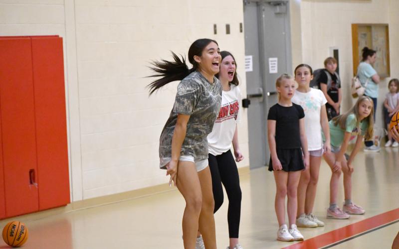 Wesley Branch/The Clayton Tribune.  Rabun County junior Addy Beth Owens cheers as her team of Lady Cats campers competes in 3-on-3 action at the Lady Cats camp.