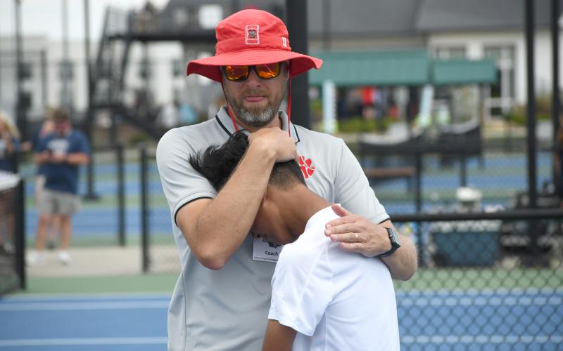 Wesley Branch/The Clayton Tribune. Rabun County head tennis coach Bryan Getty consoles his son and RCHS tennis freshman Jack Getty after the Wildcats’ loss to Brantley County in the state championship game on May 13 at the Rome Tennis Center. Getty played No. 2 singles for the Wildcats this season .