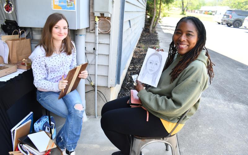 Megan Horn/The Clayton Tribune. Reese Bishop, 15, draws a portrait of Veronica Respress during the EdVentures Resource Center Kids’ Market that ran May 5-7.