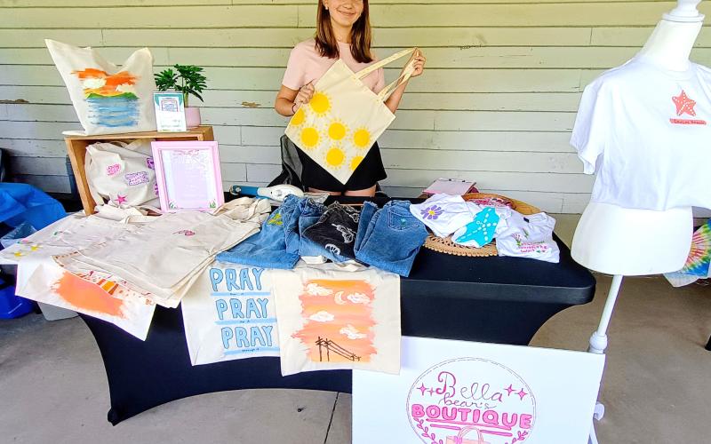 Megan Horn/The Clayton Tribune. Bella Ciochetti, 13, sells products from her business “Bella bean’s Boutique” during last week’s EdVentures Resource Center Kids’ Market.