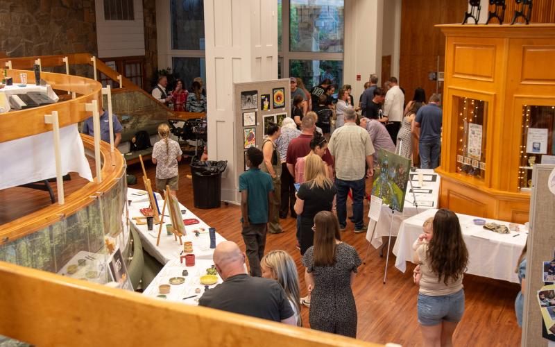 Photo courtesy of Elisha Boggs. Guests visit the Evening of the Arts packed with artwork, culinary art delights, demonstrations, music, and song.