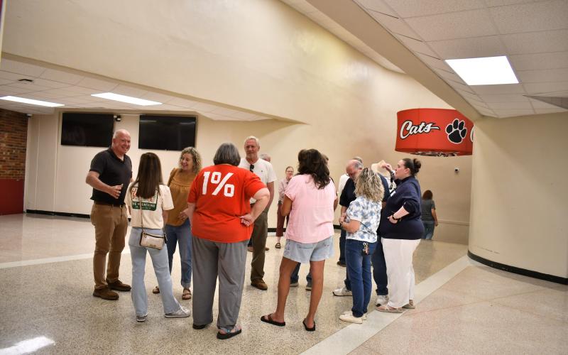 Megan Horn/The Clayton Tribune. Rabun County High School Class of 1984 graduates reminisce as they walk through the hallways of RCHS the final time on May 16. Pictured are back row from left: Danny Flory, Ronald Deal and Ronnie McKay. Front row from left: Tracy Grigg Hardin, April Mitchell Deal, Natalie Rogers Fricks, Lesia Lovell Parker and Rick Story.