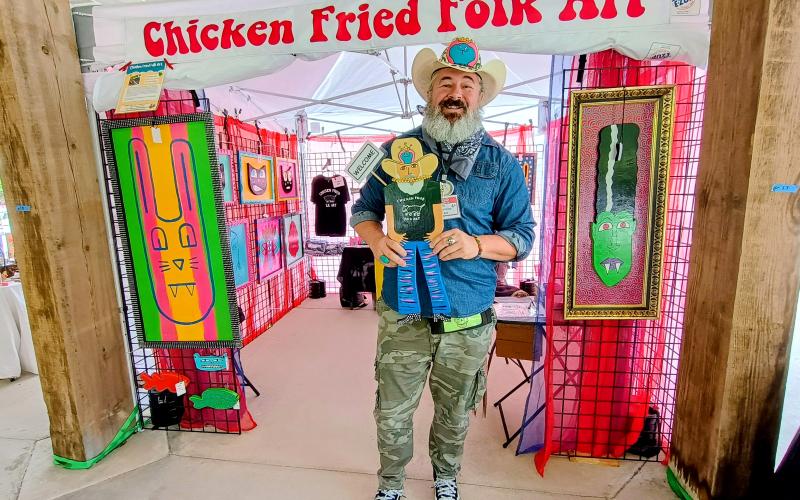 Megan Horn/The Clayton Tribune. Chris Allison features his Chicken Fried Folk Art at last weekend’s Dingerfest event held at the pavilions in downtown Clayton.