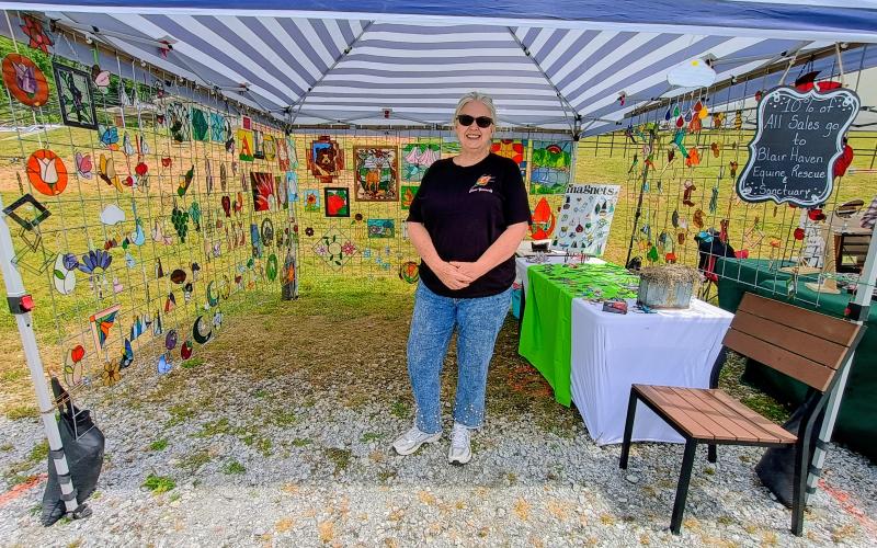 Megan Horn/The Clayton Tribune. Stevie Clements, owner of the business “Glass Yourself,” presents her works during the May 9 Of These Mountains Spring MarketPlace.
