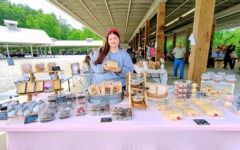 Megan Horn/The Clayton Tribune. Elizabeth Embry with Sugartopia Bakery sells decadent and delicious desserts of all sorts during the May 9 Of These Mountains Spring MarketPlace.