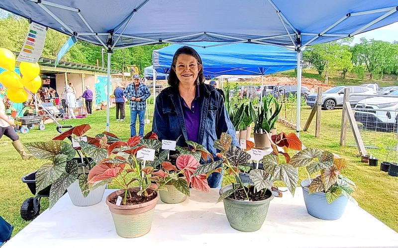 Megan Horn/The Clayton Tribune. Joan Cox happily showcases the Polka Dot Begonias she grew during the Old School Garden (OSG) Spring Plant Sale. The OSG is located at 837 Highway 76, Clayton, in the Clayton City Hall Complex.