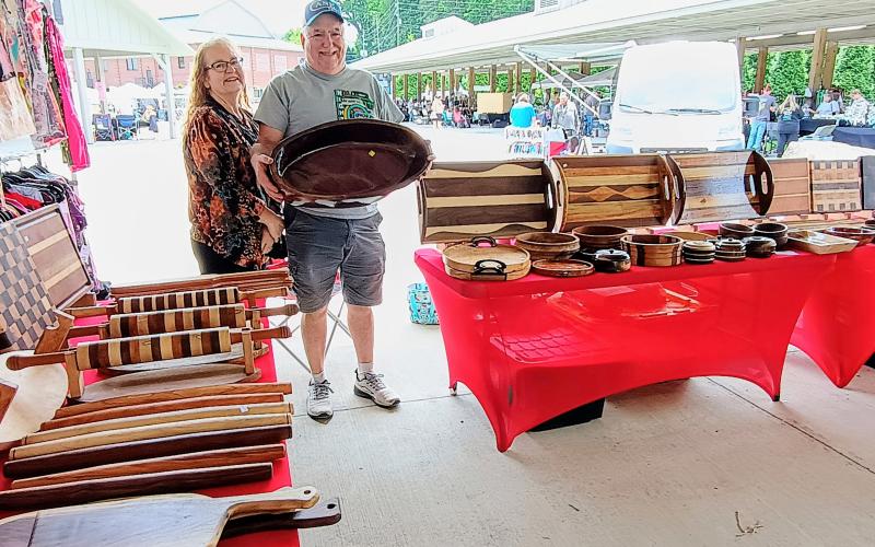 Megan Horn/The Clayton Tribune. Brad Shedd and Sheila Shedd participate in the Of These Mountains Spring MarketPlace with their beautiful wooden creations. These are made using a wood lathe and feature different woods including Walnut, Maple and Cherry.