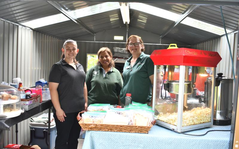Megan Horn/The Clayton Tribune. Sydney Jackson, Renee Smagur and Marina Long with UGA Extension and Habersham County 4-H attend the plant sale.