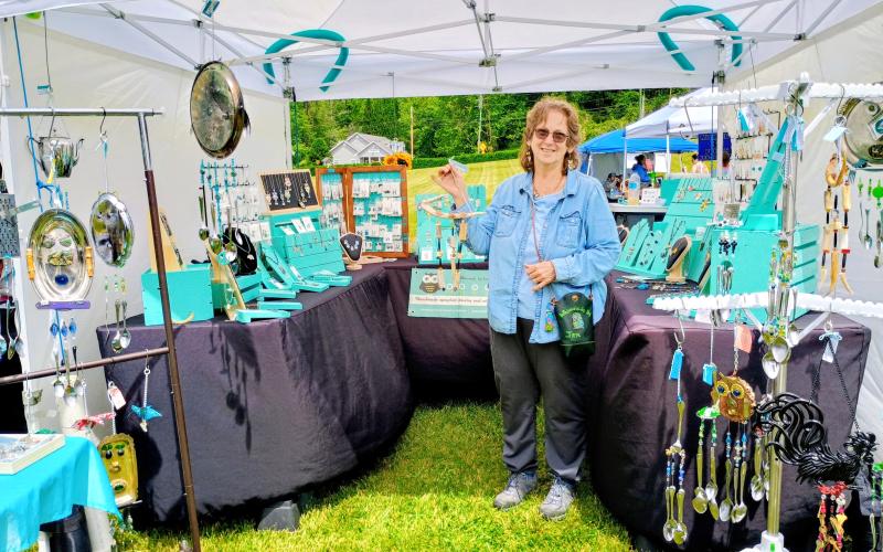 Megan Horn/The Clayton Tribune. Jennifer Strall of Cullowhee, N.C., and owner of “Whimsicals by Jen” features her handmade, upcycled jewelry and windchimes during the May 9 Of These Mountains Spring MarketPlace. She uses different materials in her works including recycling cans, watch pieces and tea pots.