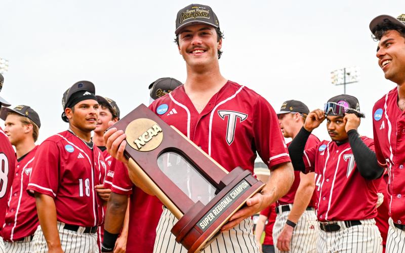 Aliza Chambers/Troy University. Rabun Gap graduate Dylan Alonso of Troy holds the Super Regional Champion trophy. Troy advanced to the College World Series.