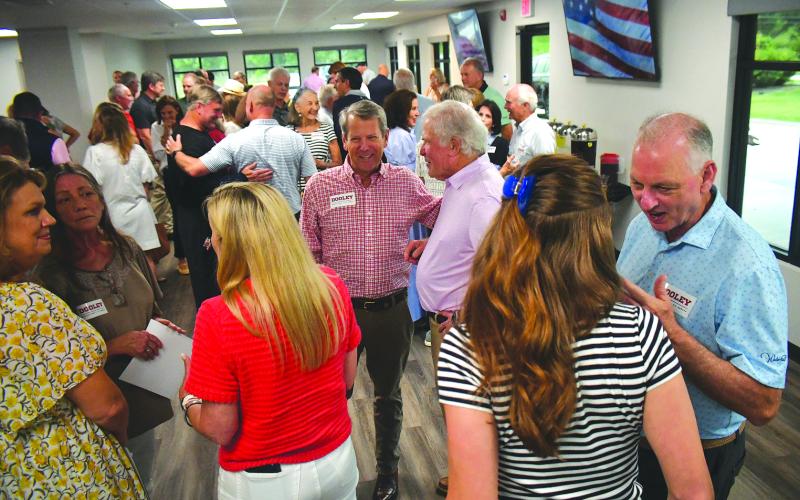 Enoch Autry/The Clayton Tribune. Gov. Brian Kemp (center) talks with constituents on May 29 at a Rabun County Meet &amp; Greet with the governor and Derek Dooley, who is running for the U.S. Senate seat. The event was held at the Wildcat Grill in Tiger for Dooley, a Clayton resident.
