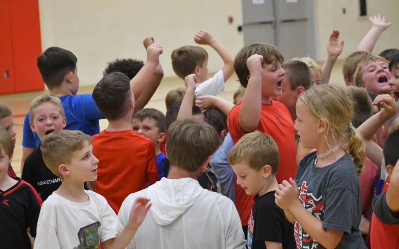 Wesley Branch/The Clayton Tribune.  The younger age group of campers at the Rabun County basketball camp at the Rabun County Recreation Department wrap up day two of camp on June 2. In the middle is RCHS head coach David Adcock.