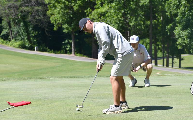 Wesley Branch/The Clayton Tribune. Rabun County head golf coach Wes Holcombe watches his putt during the Wildcat Open golf tournament at Kingwood Golf Club on June 5. Holcombe and the RCHS golf program put the tournament together to benefit the RCHS boys and girls golf teams.