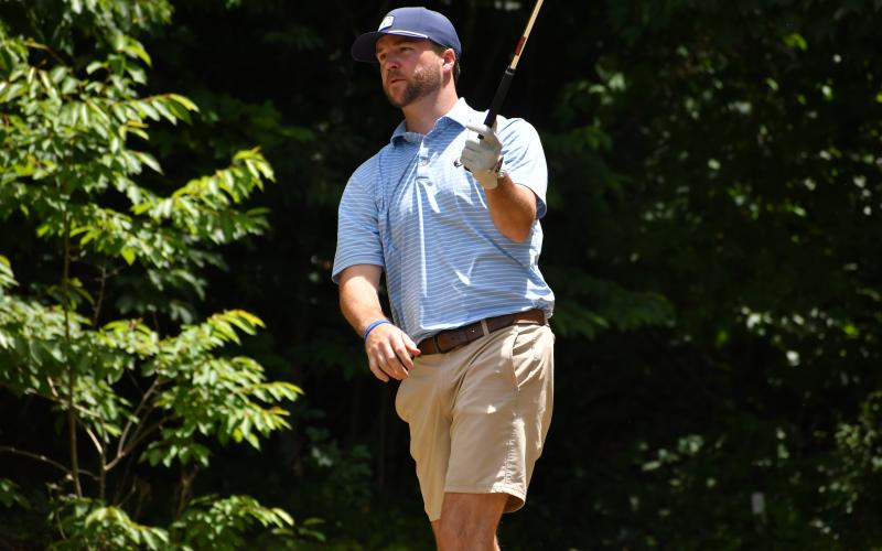Wesley Branch/The Clayton Tribune. Nick Howell holds his follow through as he watches his tee shot during the Wildcat Open golf tournament at Kingwood Golf Club on June 5. Sixteen teams signed up for the 2-man scramble tournament to benefit the RCHS Wildcat golf programs.