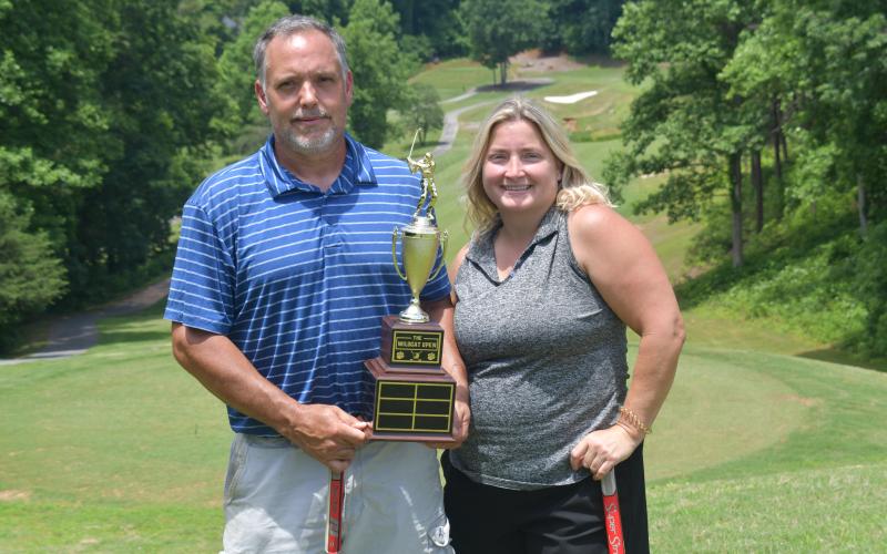 Wesley Branch/The Clayton Tribune. Jamie Smith (right) and Jason Murphy pose with the Wildcat Open trophy after winning the inaugural Wildcat Open Tournament on June 5 at Kingwood Golf Club. Smith and Murphy will have their names and score placed on the trophy, which will be displayed on RCHS’ campus.