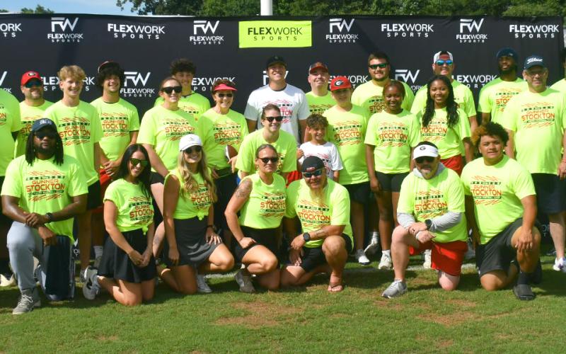 Enoch Autry/The Clayton Tribune. Gunner Stockton (back center) poses for a photo with the group of volunteers at the UGA quarterback’s football camp at Lakeview Academy in Gainesville, Ga., on June 20. The campers had the chance to catch a pass from Stockton and go through a series of fundamental drills.