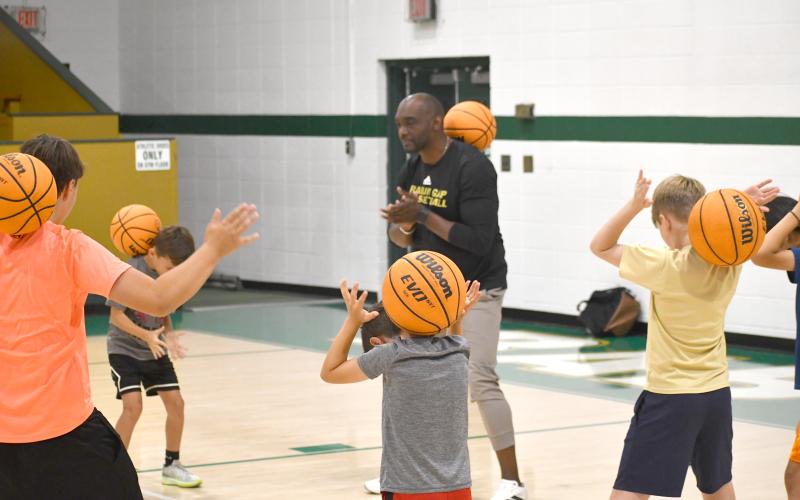 Wesley Branch/The Clayton Tribune. Rabun Gap head boys basketball coach Devin Liferidge works with campers during drills at Rabun Gap’s kids basketball camp on June 8. During Liferidge’s first season as the Eagles’ head coach, the team posted an 18-11 record and made the second round of the NCISAA playoffs.