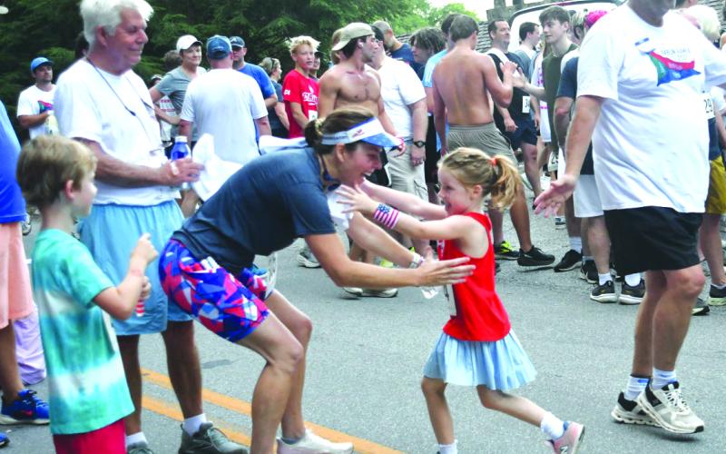 File/Enoch Autry/The Clayton Tribune. At last year’s Rabun Ramble, 5-year-old Carver Harris, runs toward the awaiting arms of her mother Courtney Harris following their 5K runs at the event in Lakemont. This year’s Rabun Ramble will be Saturday, July 4.