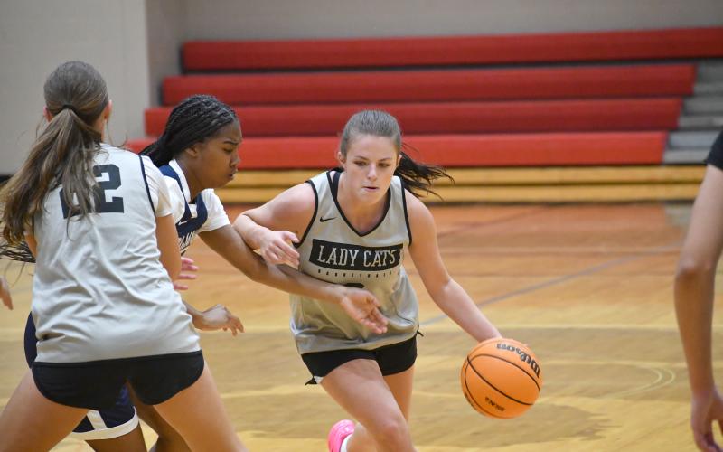 Wesley Branch/The Clayton Tribune. Rabun County rising senior Adelyn Thompson dribbles off a screen from teammate Cheyenne Queen during Rabun County’s summer scrimmage win versus Lamar County, 55-50. Thompson earned first-team All-Region honors during her junior season.