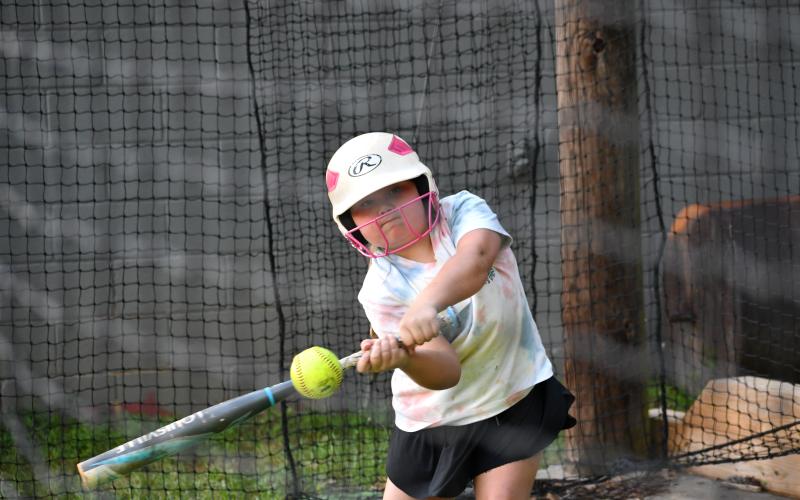 Wesley Branch/The Clayton Tribune. During the RCHS camp, the softball campers of all ages hit the batting cages to practice their swing.