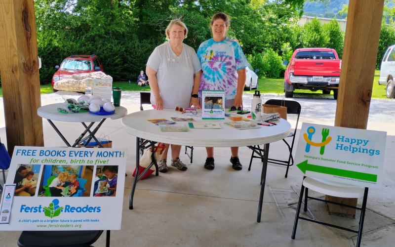 Megan Horn/The Clayton Tribune. Nancy Gribble with Ferst Readers of Rabun County, left, and Laura Lane, coordinator for Family County Family Connection, provide resources to community members during the June 13 Community Celebration. Rabun County Family Connection is offering free meals for kids and teens ages 18 and under until July 24 as part of the Happy Helpings: Georgia’s Summer Food Service Program and the USDA Summer Food Service Program.