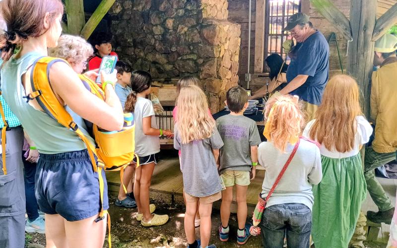 Megan Horn/The Clayton Tribune. Jim Enloe demonstrates the Heritage Skill of Flintknapping during Foxfire Heritage Days on Friday, June 5, and Saturday, June 6.