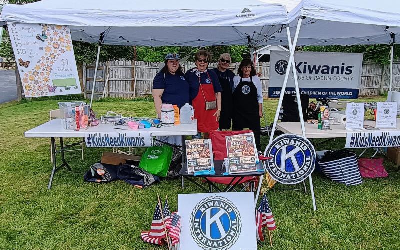 Megan Horn/The Clayton Tribune. Konstantina Kalaitzaki Vinson; Cricket Werkheiser; Laura Schott, Kiwanis Club of Rabun County president; and Debbie Chisholm have fun helping kids at the Tallulah Kids’ Corner during Ramshackle last weekend.