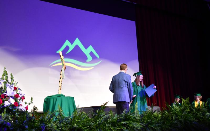 Megan Horn/The Clayton Tribune. Rabun Mountain Education Class of 2026 graduate Anna Beth Richardson shows a huge smile as she accepts her high school diploma from Rabun Mountain Education Campus Principal Allen Blair.
