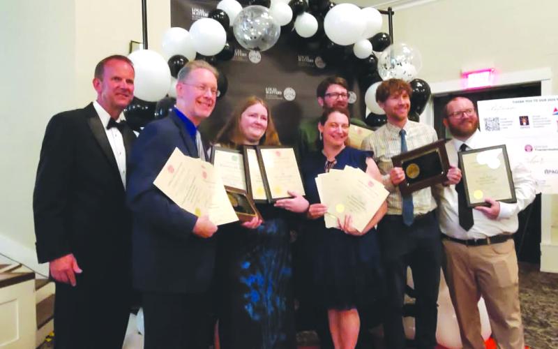 Photo provided. Publisher Enoch Autry (second from left) displays awards won by The Clayton Tribune at the Georgia Press Association (GPA) Better Newspaper Contest on June 12. Autry stands with Regional Publisher Keith Barlow, the outgoing GPA president, far left, and Community Newspapers Inc. staff members from The Northeast Georgian and The Dahlonega Nugget, who all earned multiple awards during the banquet.