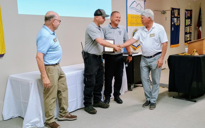 Megan Horn/The Clayton Tribune. Paramedic Tate Nichols, second from left, shakes hands with Rotary Club of Clayton President Matt Freeman after receiving the 2026 EMT/Paramedic of the Year award from the Rotary Club of Clayton during the Thursday, June 4 lunch meeting. Pictured also are EMS Capt. Trampes Stancil and Rotrarian Stewart Harvard.