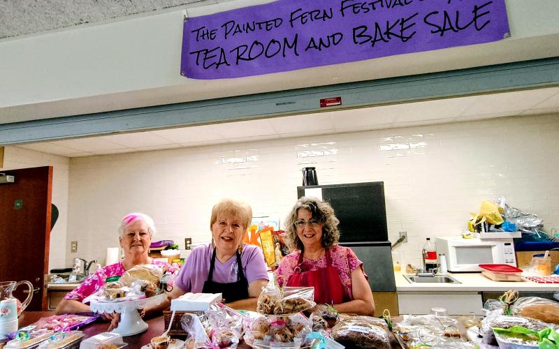 Megan Horn/The Clayton Tribune. Jan Timms, Cricket Werkheiser and Nancy Robinson distribute baked goods in The Painted Fern Festival of Art Tea Room and Bake Sale on Saturday, July 11. The two-day festival was presented by the North Georgia Arts Guild. Proceeds from the bake sale and Art-4-A-Buck raises funds for the Guild Scholarship Fund.