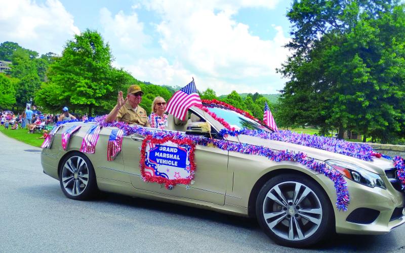 Megan Horn/The Clayton Tribune. Sky Valley Purple Heart Recipient Bruce Gant was this year’s Sky Valley Independence Day Parade Grand Marshal on Friday, July 3. He rides in the parade next to his wife, Vicky.