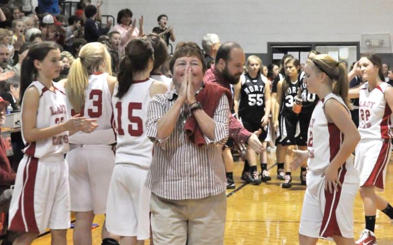 Submitted Photo. Former Rabun County Middle School girls basketball coach Janice Wayne takes in a win by her Ladycat team during her coaching career. Wayne spent 38 years as a teacher and coach in Rabun County.